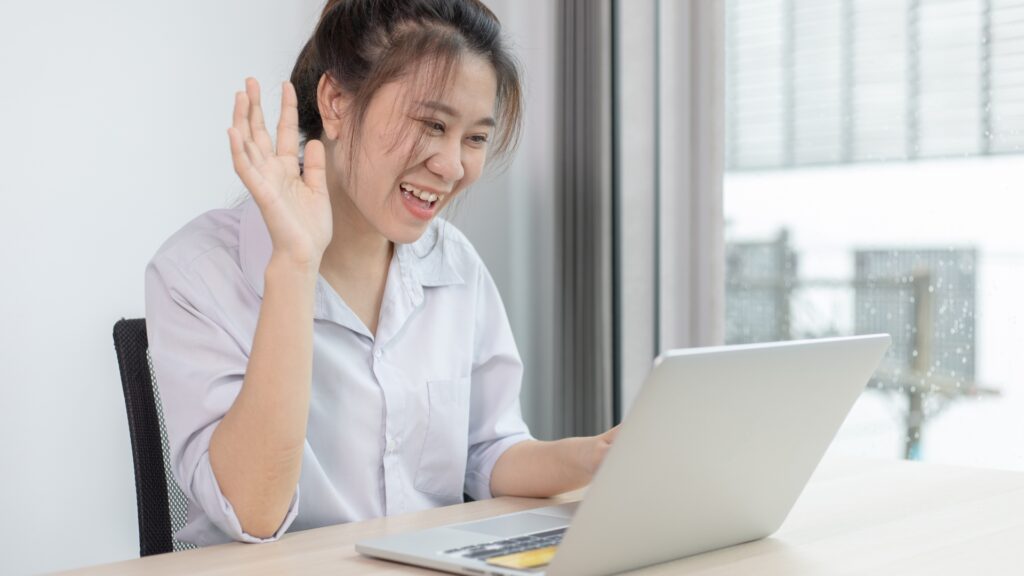 Virtual therapy session on laptop showing a client speaking with a licensed therapist via video chat.