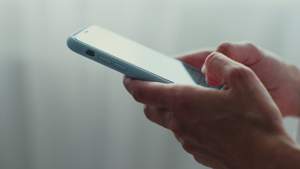 Smartphone screen showing supportive text conversation between user and online therapist using mental health apps.
