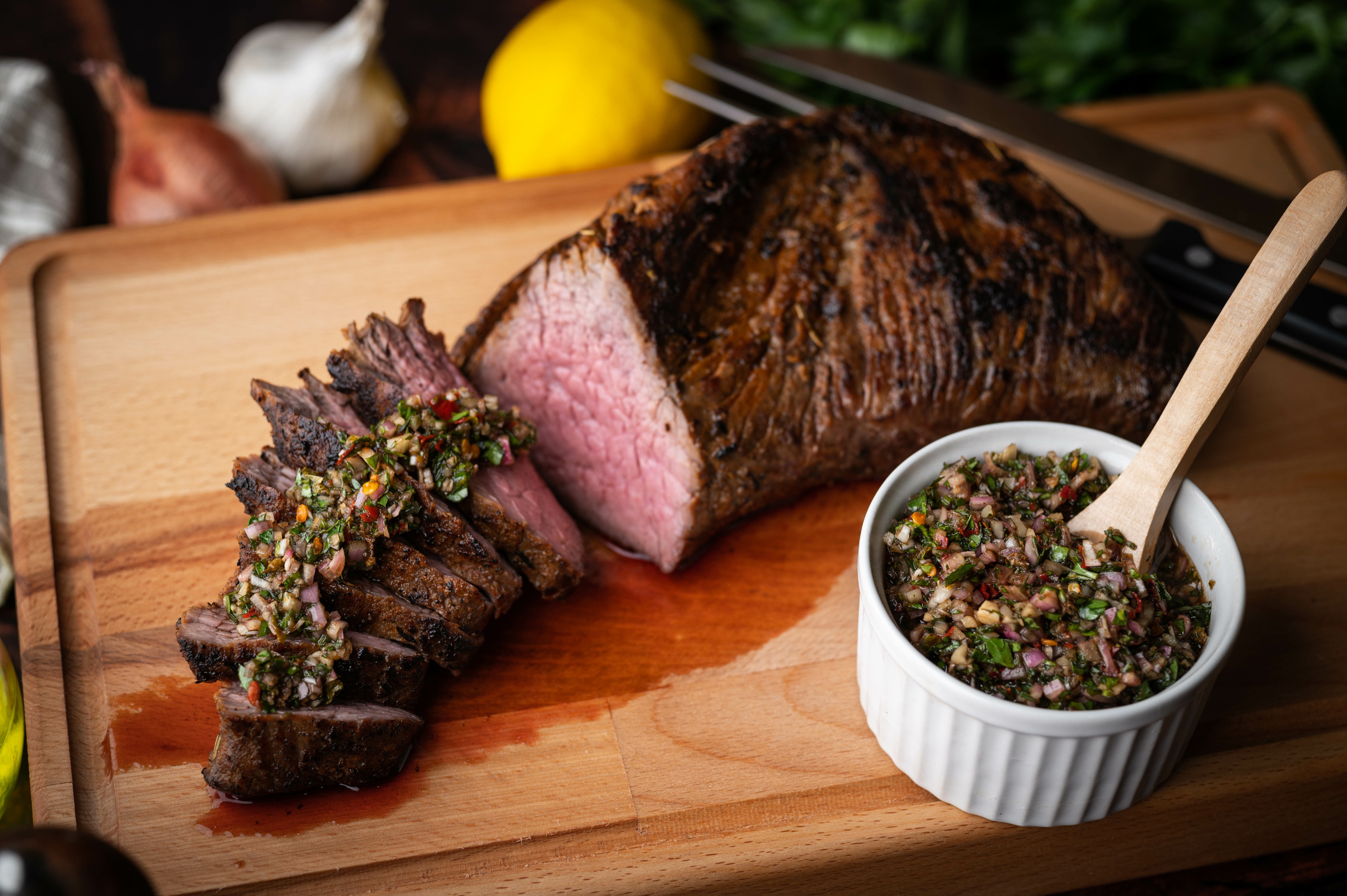 grilled tri tip steak with chimichurri sauce. Summer BBQ.