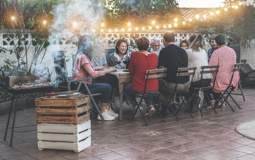 Happy family eating at barbecue party dinner - Different age of people having fun at bbq meal sitting in villa backyard - Summer lifestyle and food concept