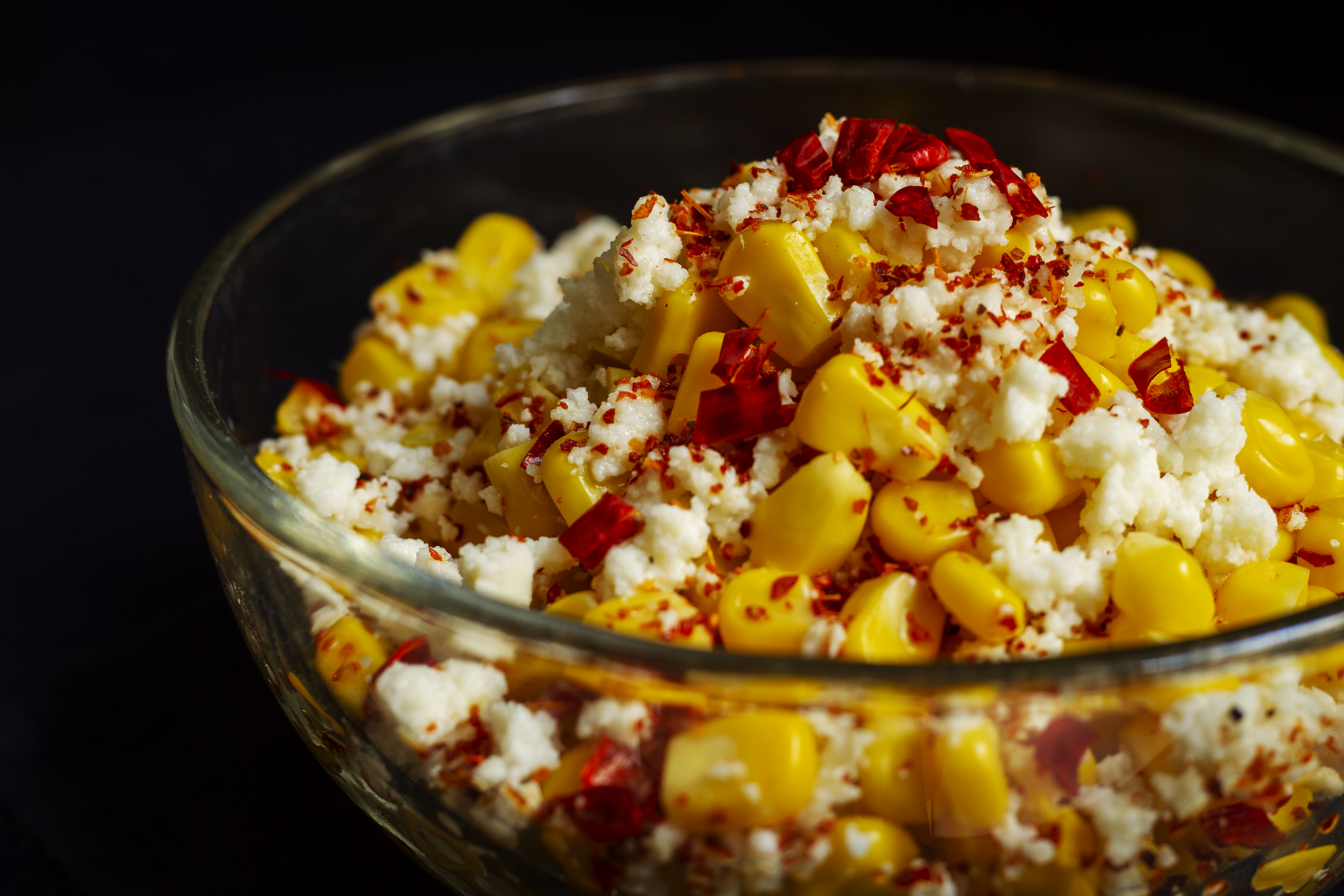 Tasty esquites (Mexican street corn dip) with spices high angle